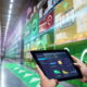Smart Augmented Reality,AR warehouse management system.Worker hands holding tablet on blurred warehouse as background