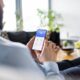An unrecognizable man holding a smartphone with smart home control system.